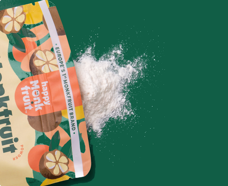 Happy Monkfruit powder pouch with spilled powder on a deep green background